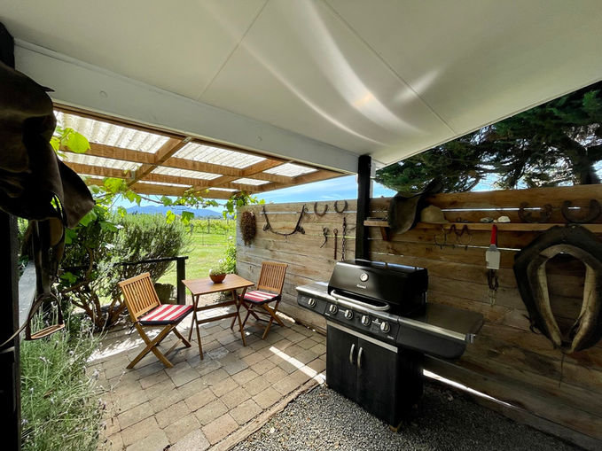 Covered courtyard with barbecue outside The Stables cottage at St Leonards Vineyard Cottages boutique accommodation in Marlborough, New Zealand