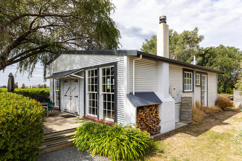 Outside view of The Woolshed accommodation entraceway and deck at St Leonards Vineyard Cottages in Marlborough, New Zealand