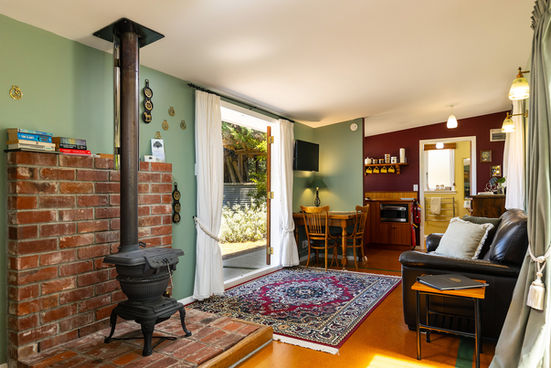 Interior view of lounge area and kitchenette inside The Stables cottage at St Leonards Vineyard Cottages boutique accommodation in Marlborough, New Zealand