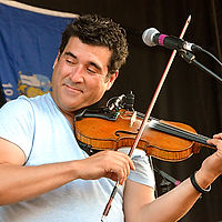 Pascal Miousse (Vishtèn) – Acadian Fiddle/Guitar Accompaniment Pascal has contributed his multi-instrumental talents to various Canadian acts encompassing a wide array of genres from folk and traditional music to swing, rock and blues, and is in high demand as an instrumental instructor at music camps and workshops worldwide. Pascal is passionate about passing on his tradition and inspiring younger generations of musicians.