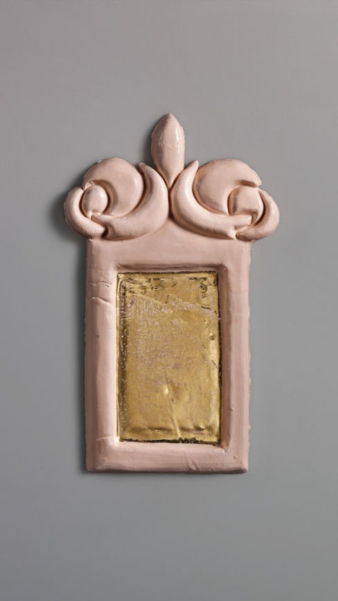 Pink ceramic mirror frame with baroque curves and a gold reflective insert on a grey background.