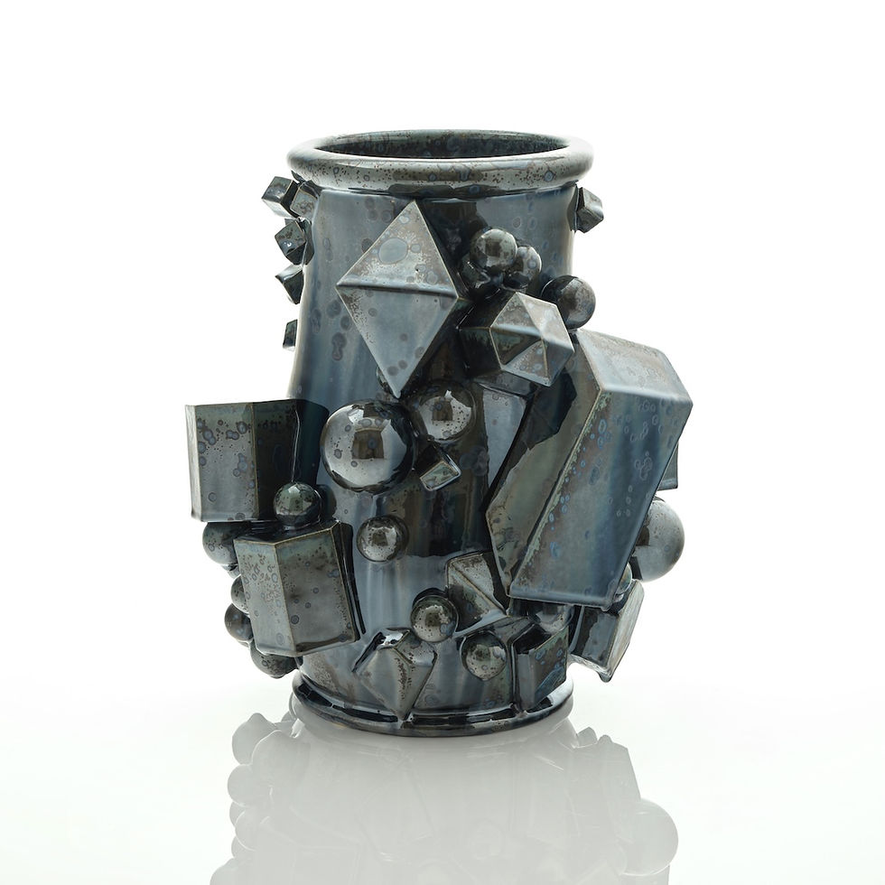 Kate Malone Black Magma Vase, 2024, crystalline-glazed stoneware with geometric forms.
Kate drawing an artich