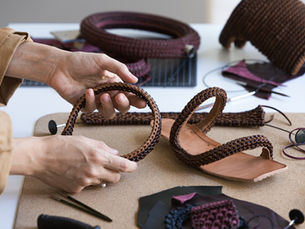Italian designer Cecilia Rinaldi working on woven leather design at Atelier Nuanda studio.
