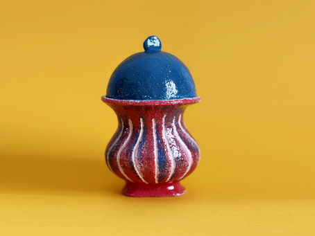 Italian ceramic vase by Anna Resmini, italian independent designer, on an orange background