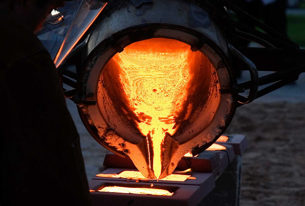 A ferrous foundry ladle pouring various grades of stainless steel.