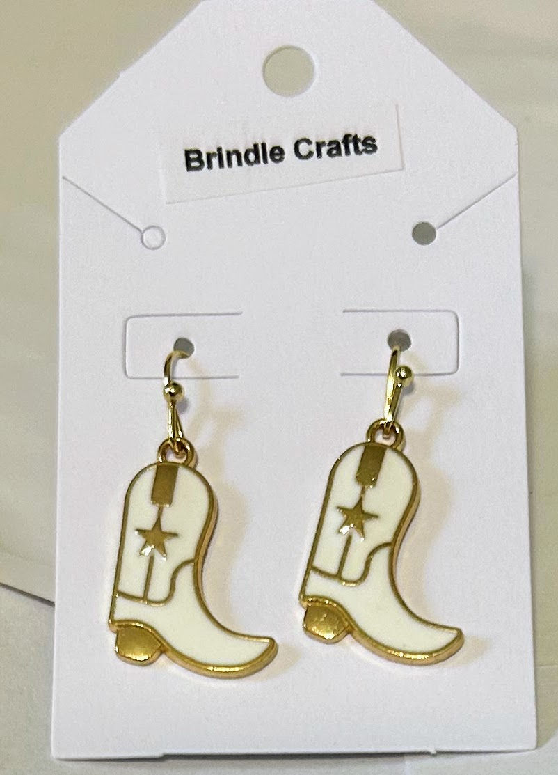 White cowboy boot earrings with gold toned accents