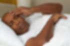 African American man having trouble slee