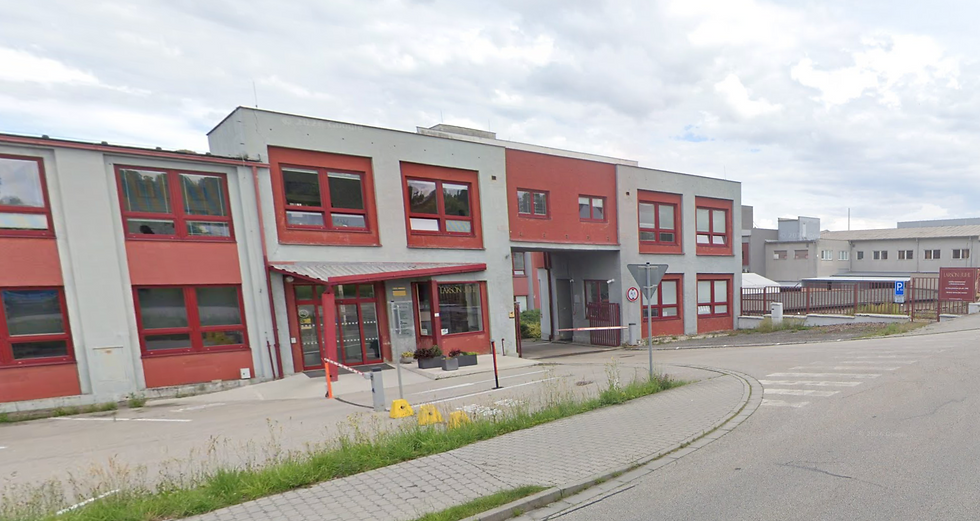 Pohled z ptačí perspektivy na vstup do průmyslového areálu s automatickou závorou