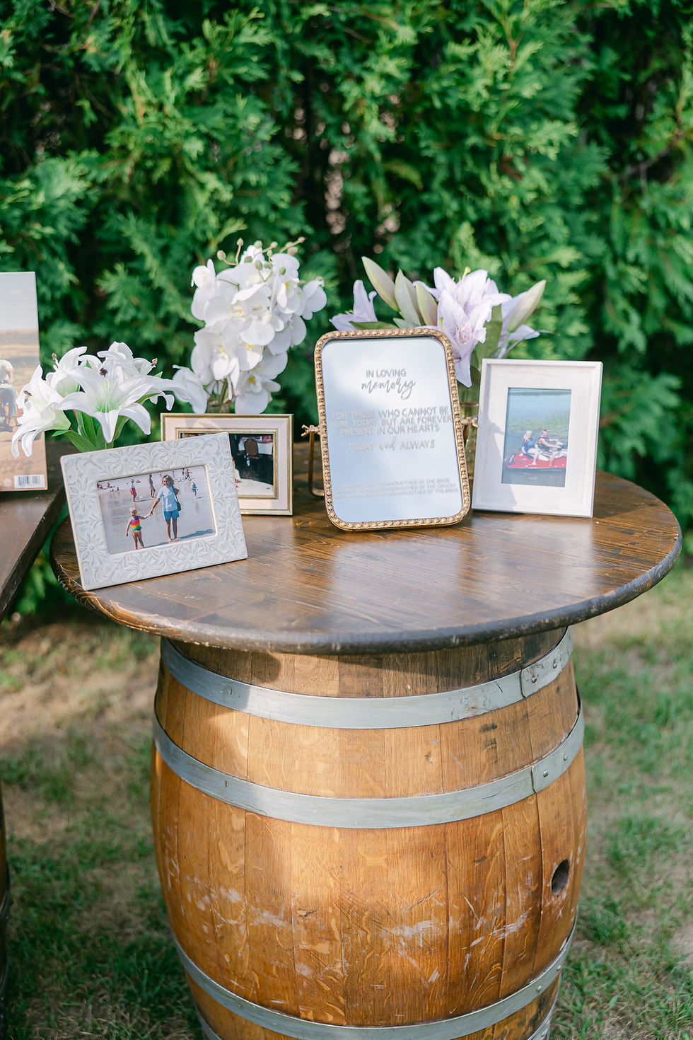 Wedding memorial table honoring loved ones with framed photos