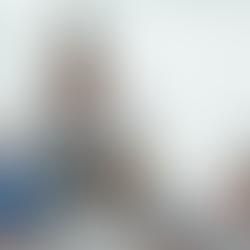 Three adults focused on laptops in an office, assisted by a smiling woman in a striped shirt. Bright blinds in the background. Craig Zuber's Weekly Edge (Blog)