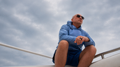 Craig Zuber reflecting on freedom, clarity, and intentional living while seated on a boat.