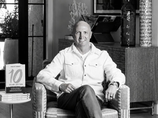 Craig Zuber seated beside copies of The 10-Year Letter before the book’s public launch.