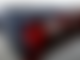 Folded American flag on reflective surface with visible stars and stripes, featuring red, white, and blue colors. Quiet, respectful mood.