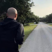 Craig Zuber walking down an open road before cancer surgery.
