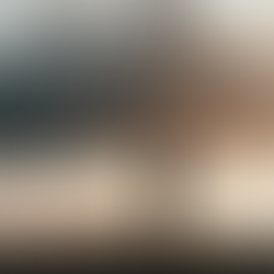 A person stands on a hilltop at sunrise, overlooking misty mountains in the background. The scene is serene with soft, warm lighting.