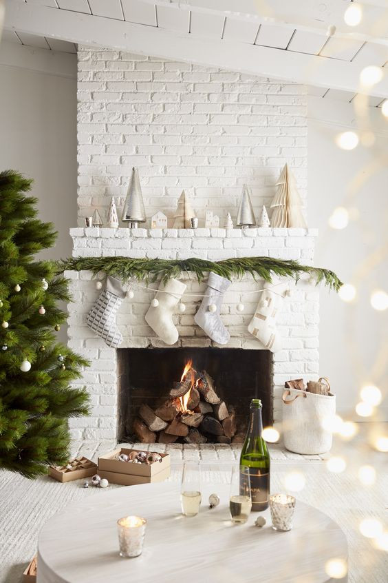 White painted brick fireplace with Christmas decoration in a white