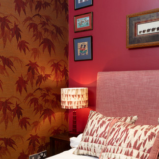 red drenched walls, leaf red wallpaper, red bed head