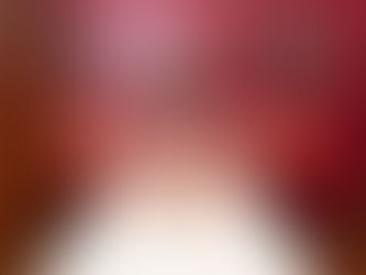 red walls, red bed head, African print cushions and lamps