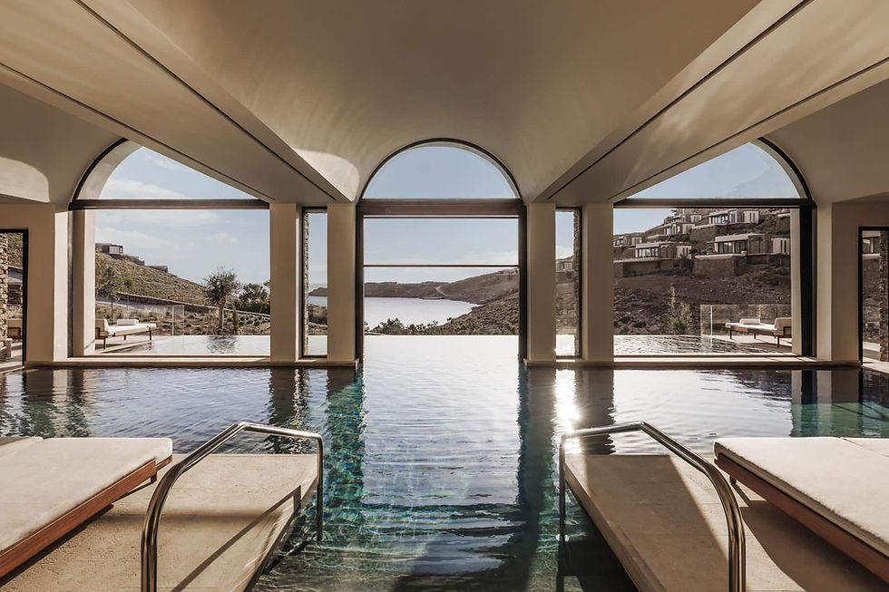 Elegant luxury resort with arched architecture and infinity pool overlooking the sea