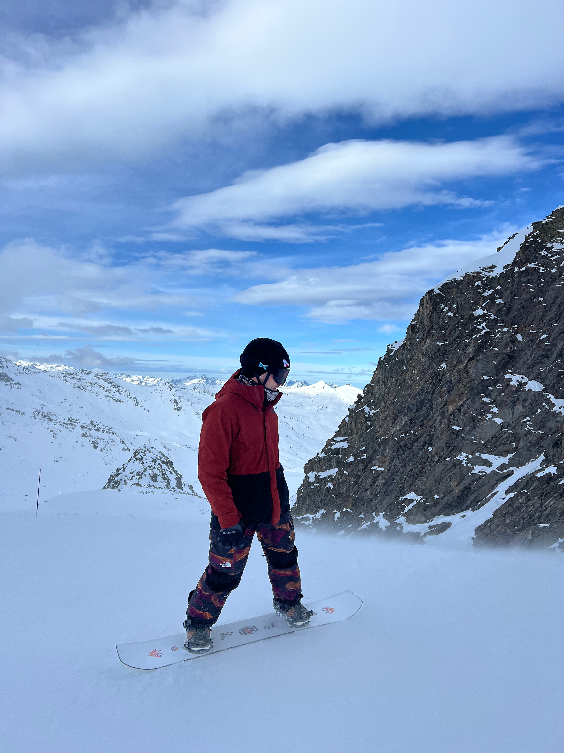 a guy on a snowboard ready to shred it down the slopes