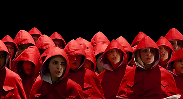 A group of young girls all wearing read capes as part of the production of Tender Young Creatures