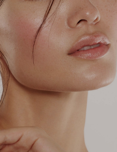 Close up of beautiful young woman's face with clear clear skin and beautiful lips with mak