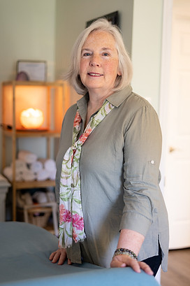 janice landfair stands in the essential wellness healing room