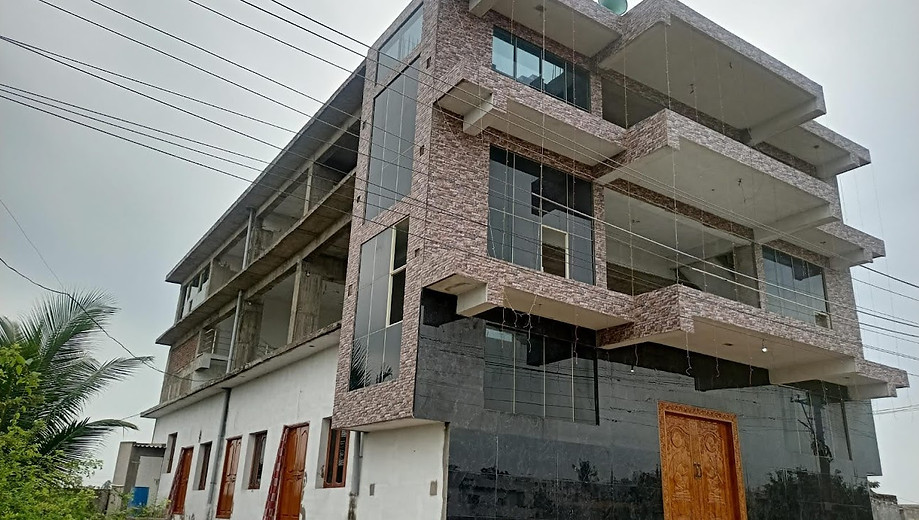Modern building under construction with glass windows; multi-story project with Building Projects.