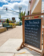 Chalkboard sign on the sidewalk.