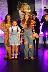 Main characters Dorothy, Scarecrow, Tinman and Lion in The Wizard of Oz Play, dressed in costumes and ready for their adventure down the yellow brick road