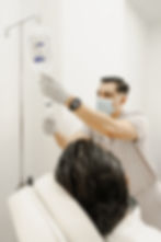 Medical professional applying intravenous therapy to a patient, showcasing IV drip treatments at Regeneris Therapy.