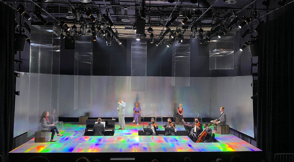 Set design of a room reflecting a rainbow prism by clifton chadick.