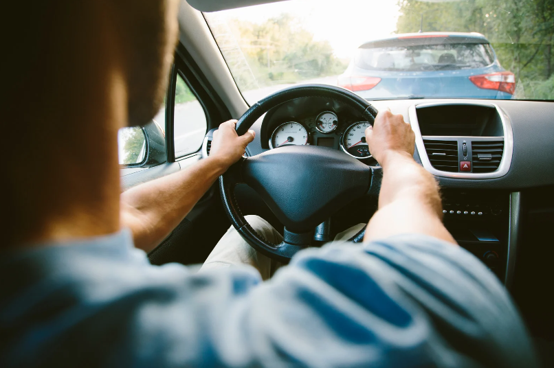 An autism life coaching client metaphorically driving the car of his life into his future.