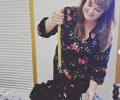 Midwife Kaleigh weighs infant during a postpartum visit