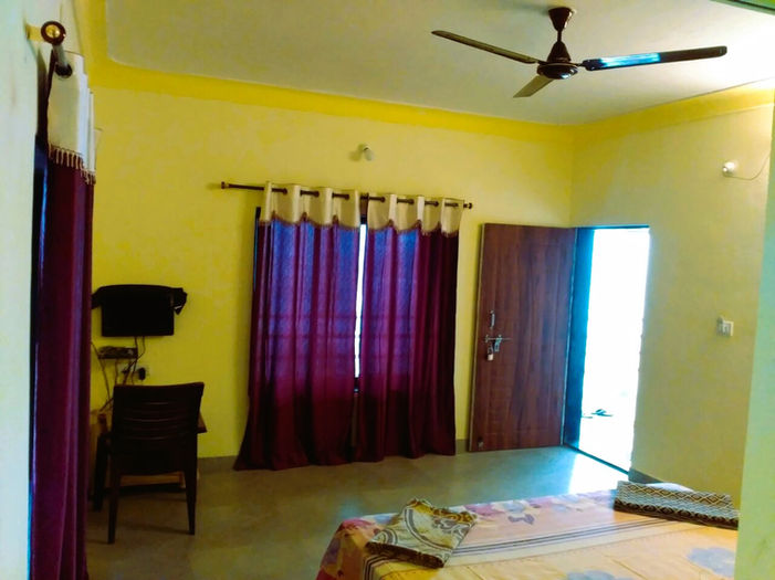 Devbag Malvan room with TV and curtains