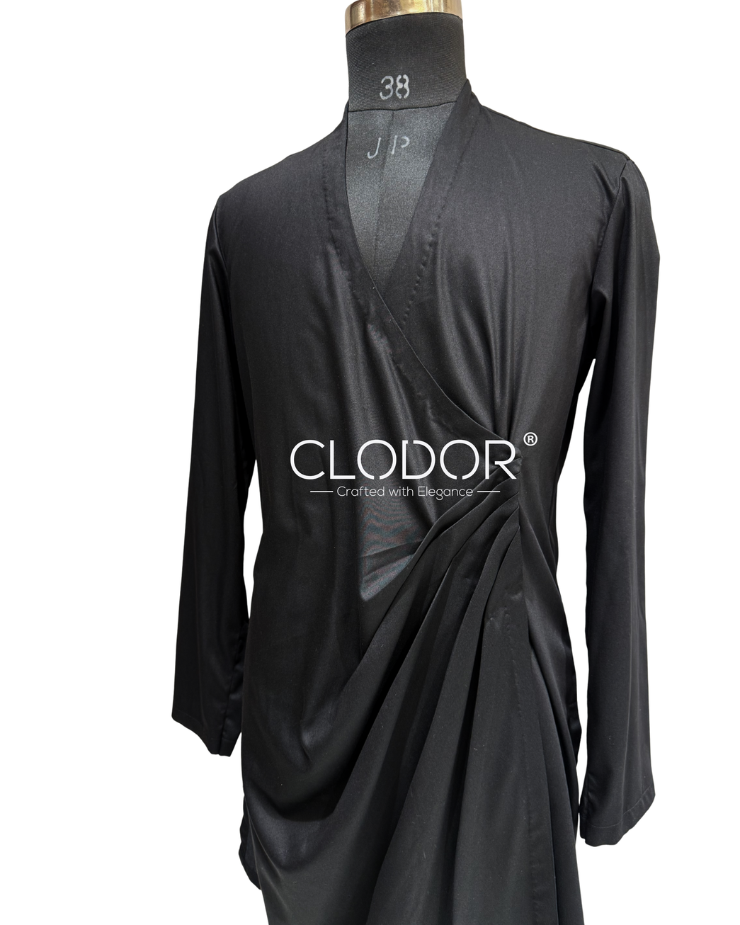 Modern black draped kurta layered with an embroidered silk shrug in a contemporary festive silhouette.