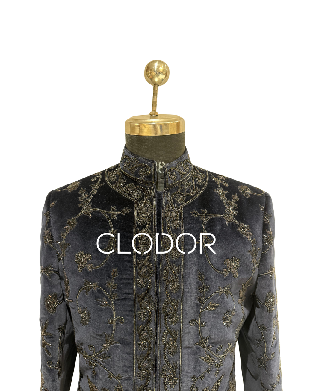 The rich metallic detailing against the deep grey velvet base creates a luxurious textured finish