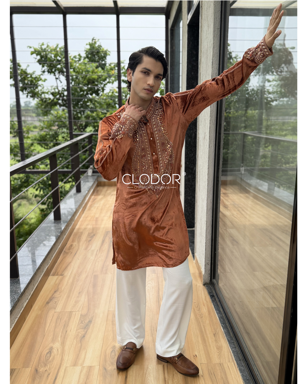 Model wearing a Rust Orange Embroidered Velvet Kurta Set with intricate hand embroidered neckline and non-crushable linen fla