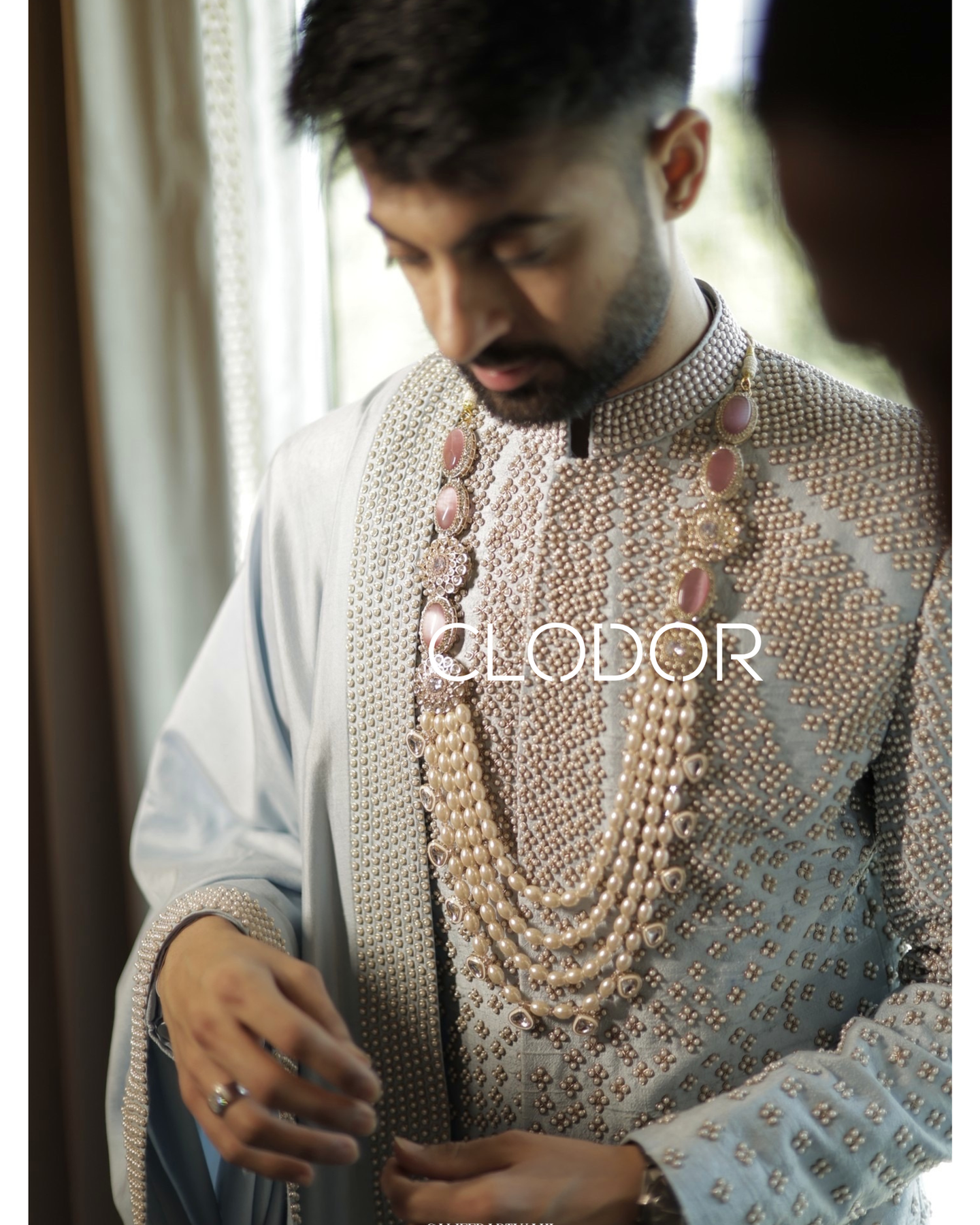 Embroidered dupatta with detailed border handwork on powder blue groom sherwani ensemble