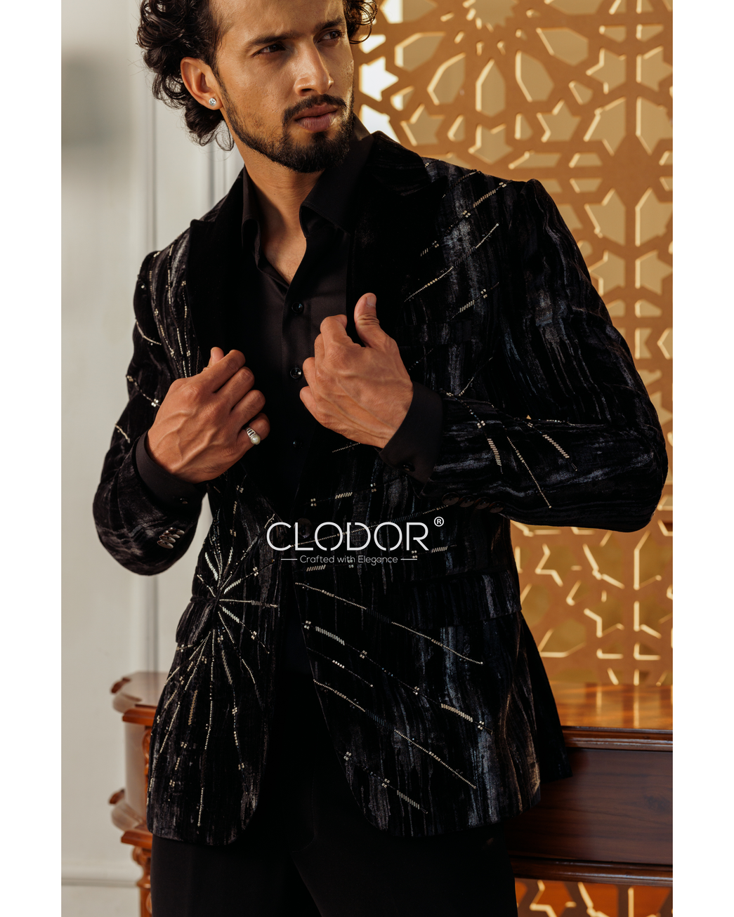 Black micro velvet tuxedo jacket with hand-embroidered sleeve detailing and peak lapels — bespoke by Clodor.