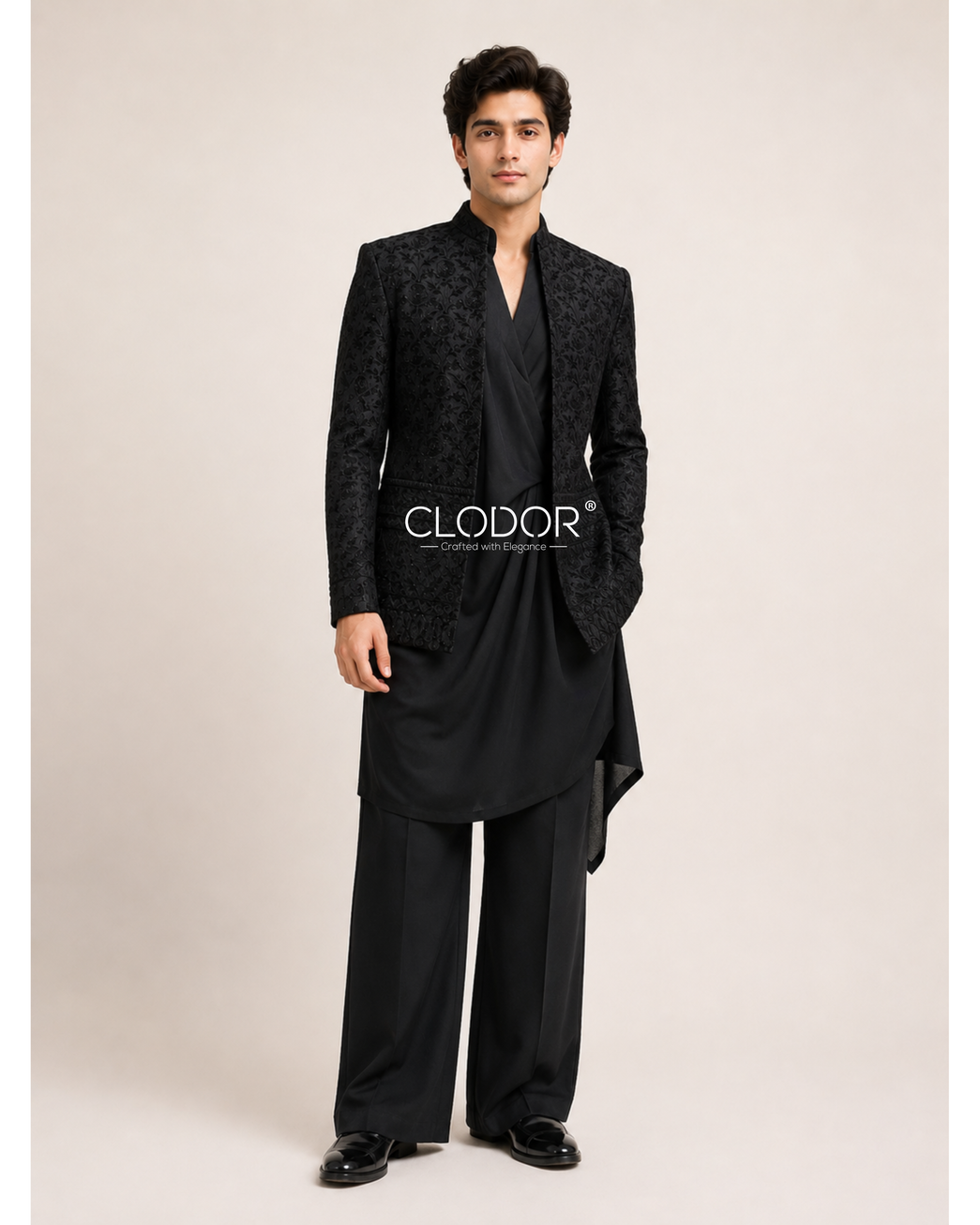 Black embroidered silk shrug layered over a draped black Tencel kurta with matching broad-bottom trousers.