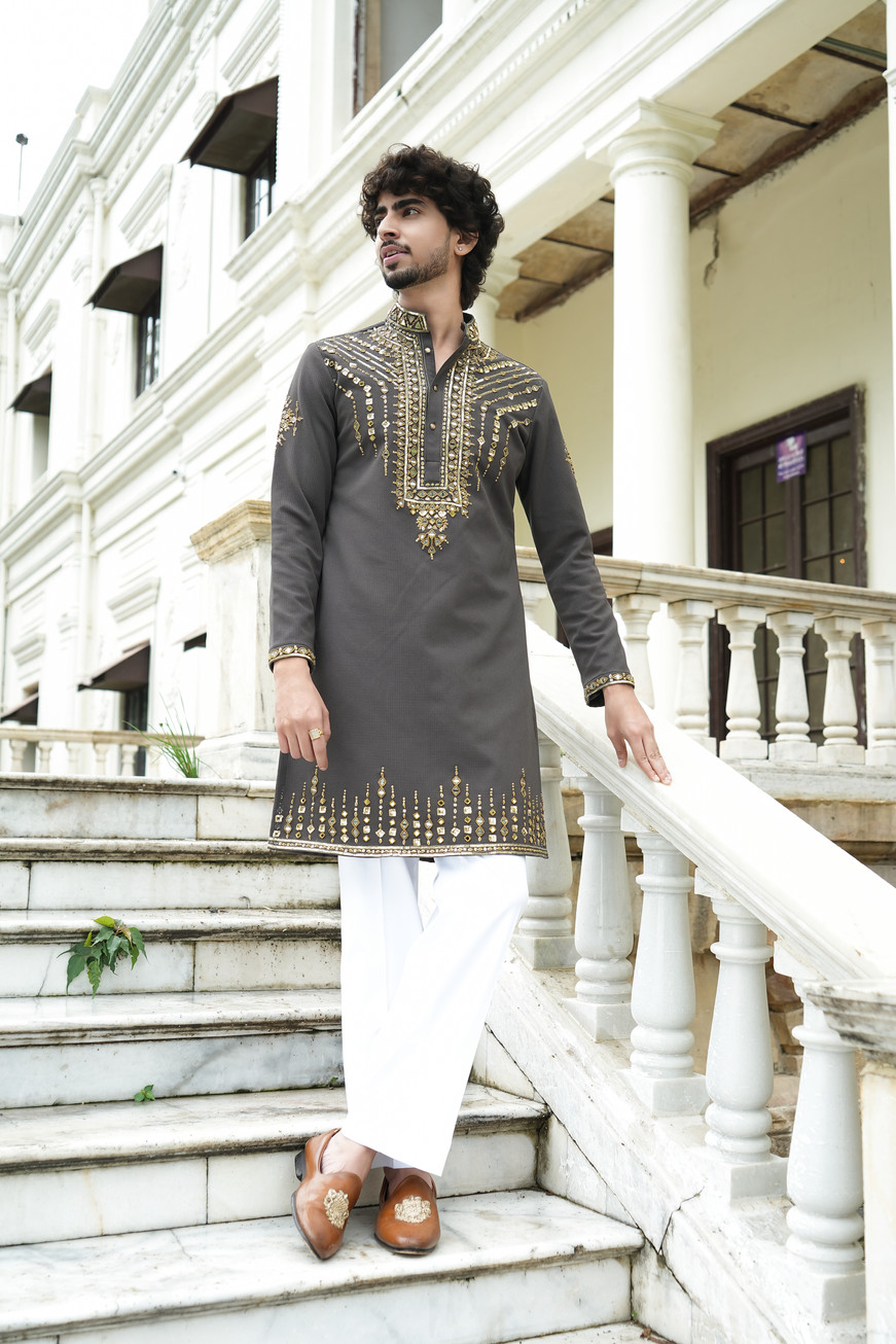 Intricate mirror work hand embroidery on neckline and sleeves of olive green Tencel kurta