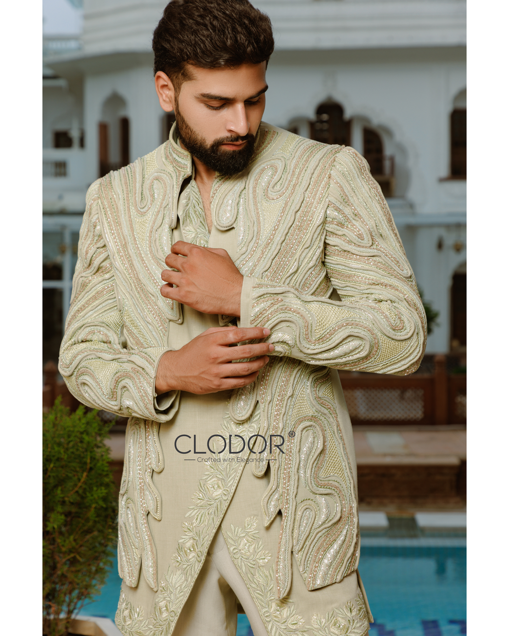 Light green embroidered short shrug with sculptural dori handwork — bespoke by Clodor.