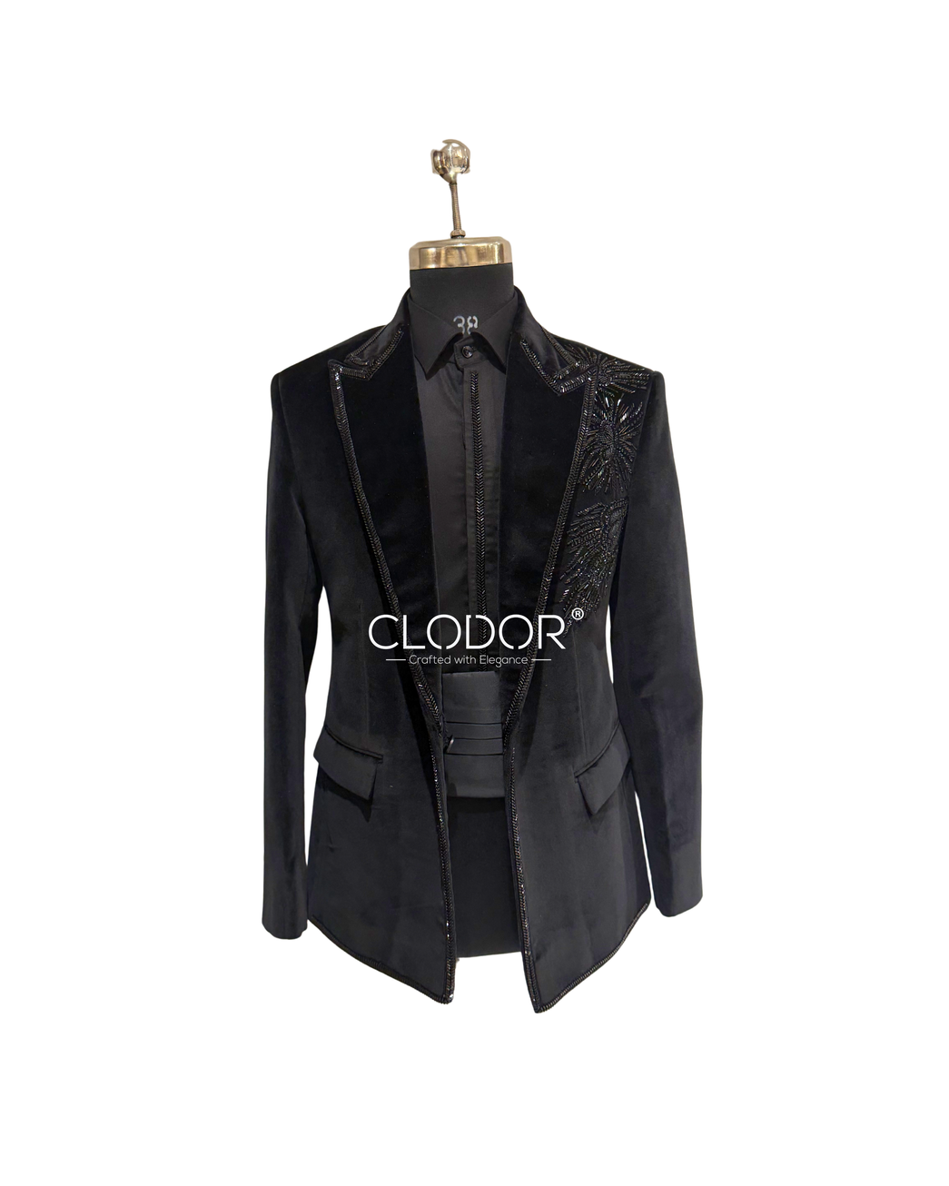 Intricate monochrome hand embroidery with pearls, cutdana, nalki, and stones on a black velvet tuxedo.