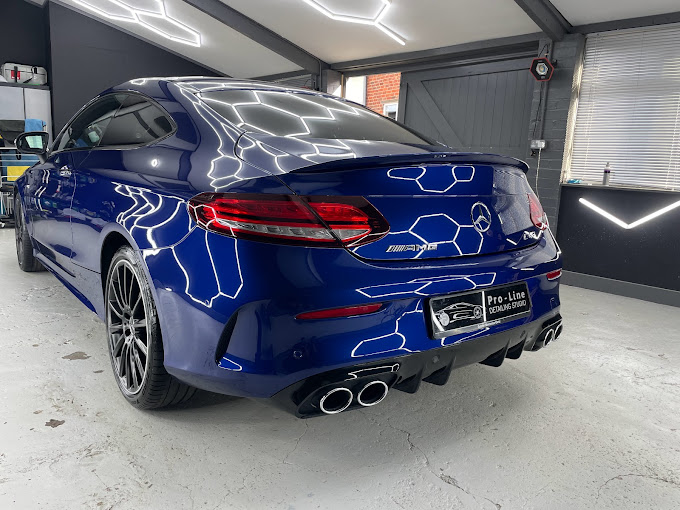 Blue Mercedes-AMG with a ceramic coating under the hexagon lights
