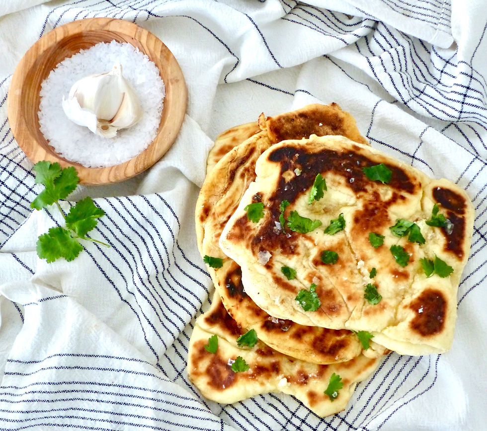 Naan bread garnished with garlic butter.