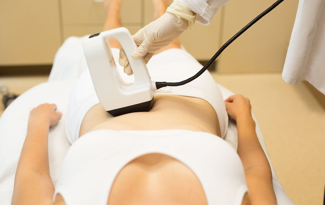 Woman is receiving body contouring and fat reduction in Vancouver.