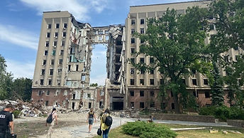 Participants moving through a damaged urban environment during hostile environment awareness training.