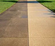 Before and after photo of concrete surface professionally pressure washed in Superior, WI, highlighting removal of embedded d