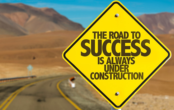 The Road to Success is Always Under Construction sign on desert road.jpg